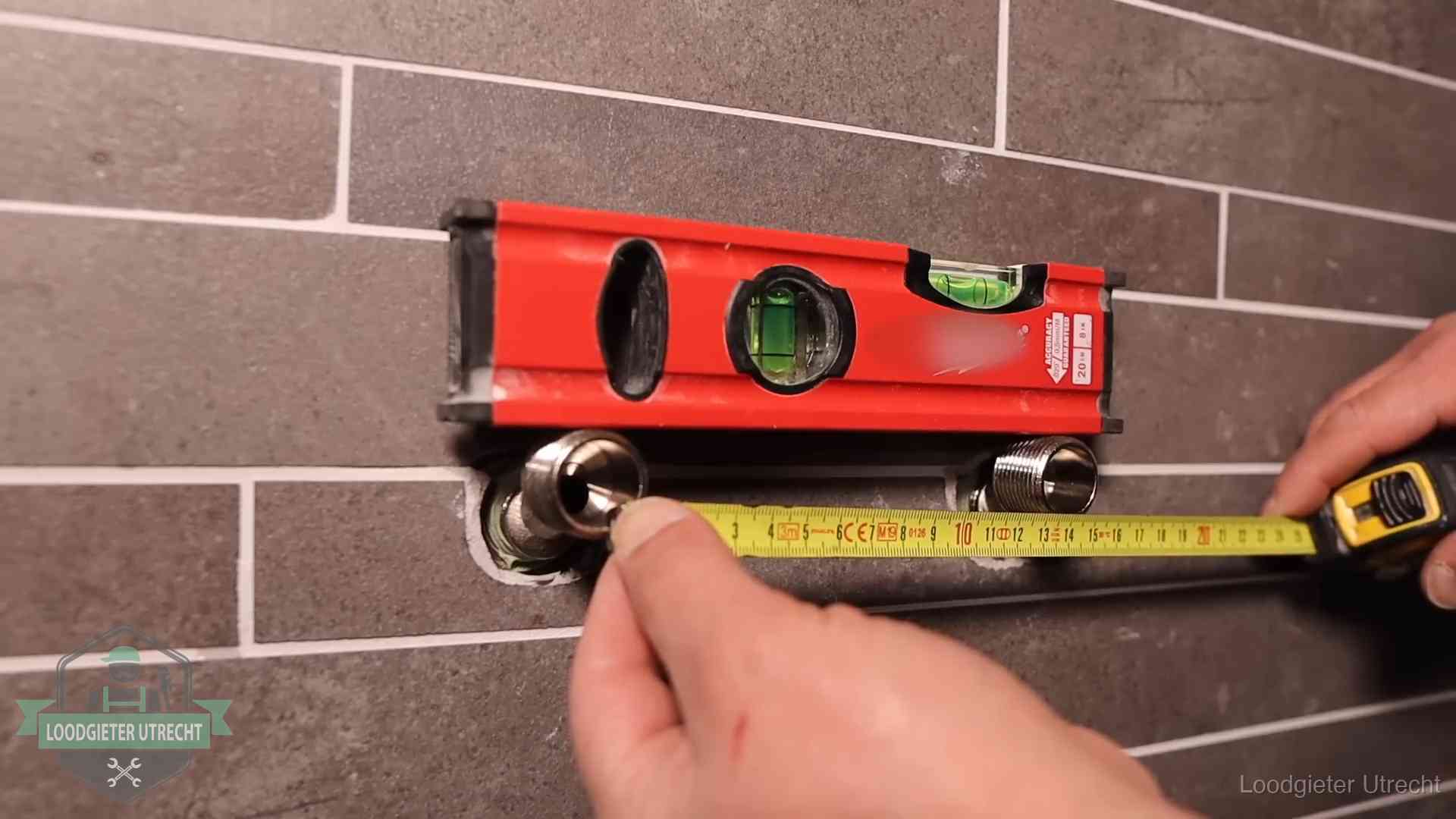 Waterpas en duimstok bij kraan-aansluitpunten in een badkamer in Utrecht